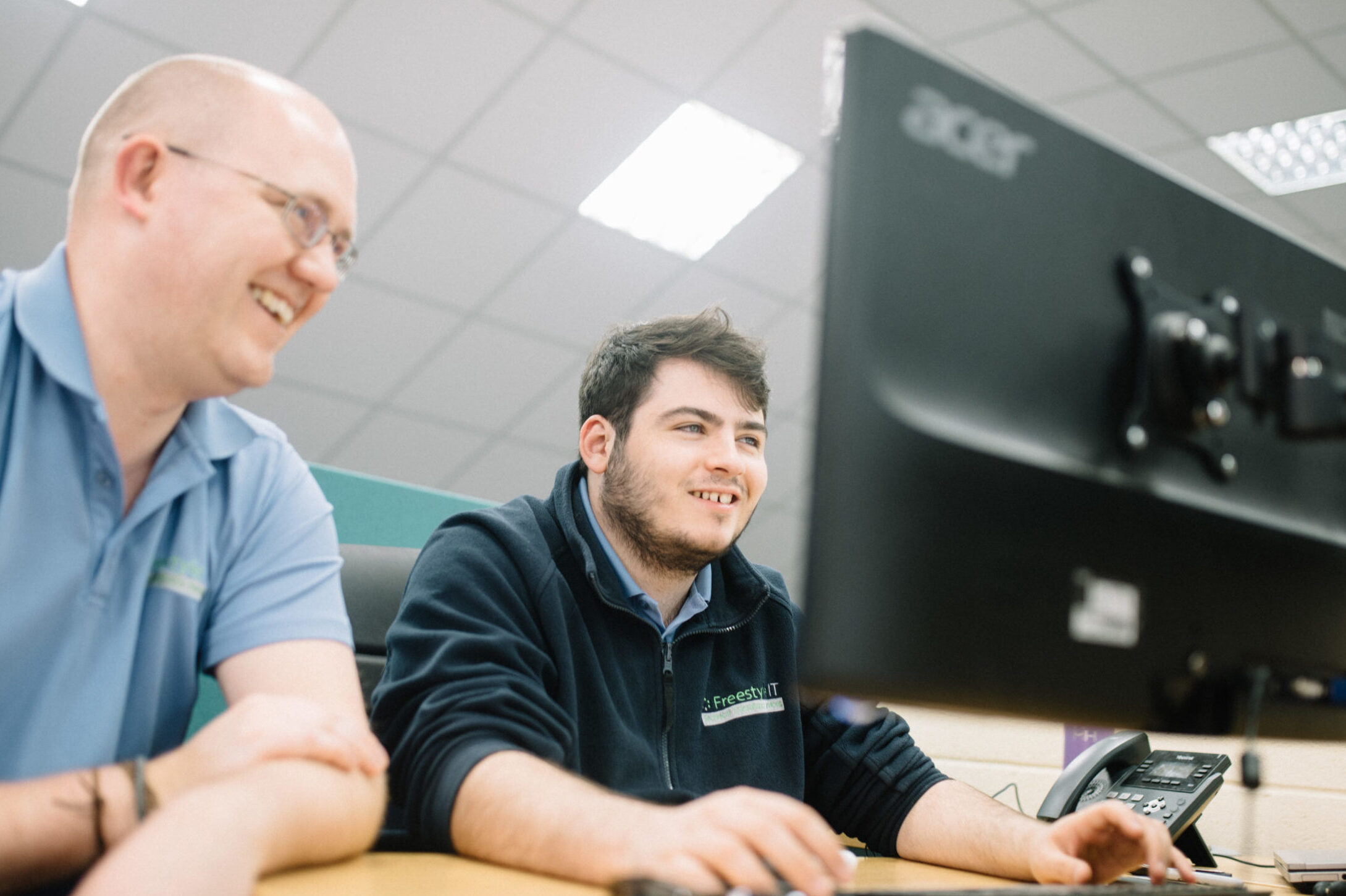Freestyle TS employees at computer